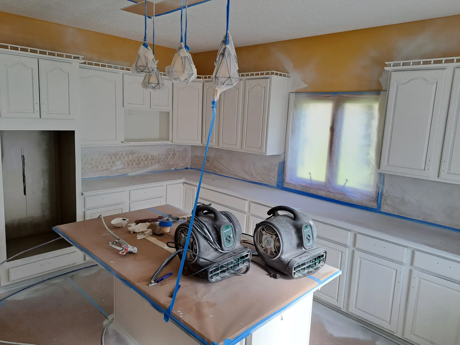 Kitchen masked off during cabinet spraying in Avon, IN