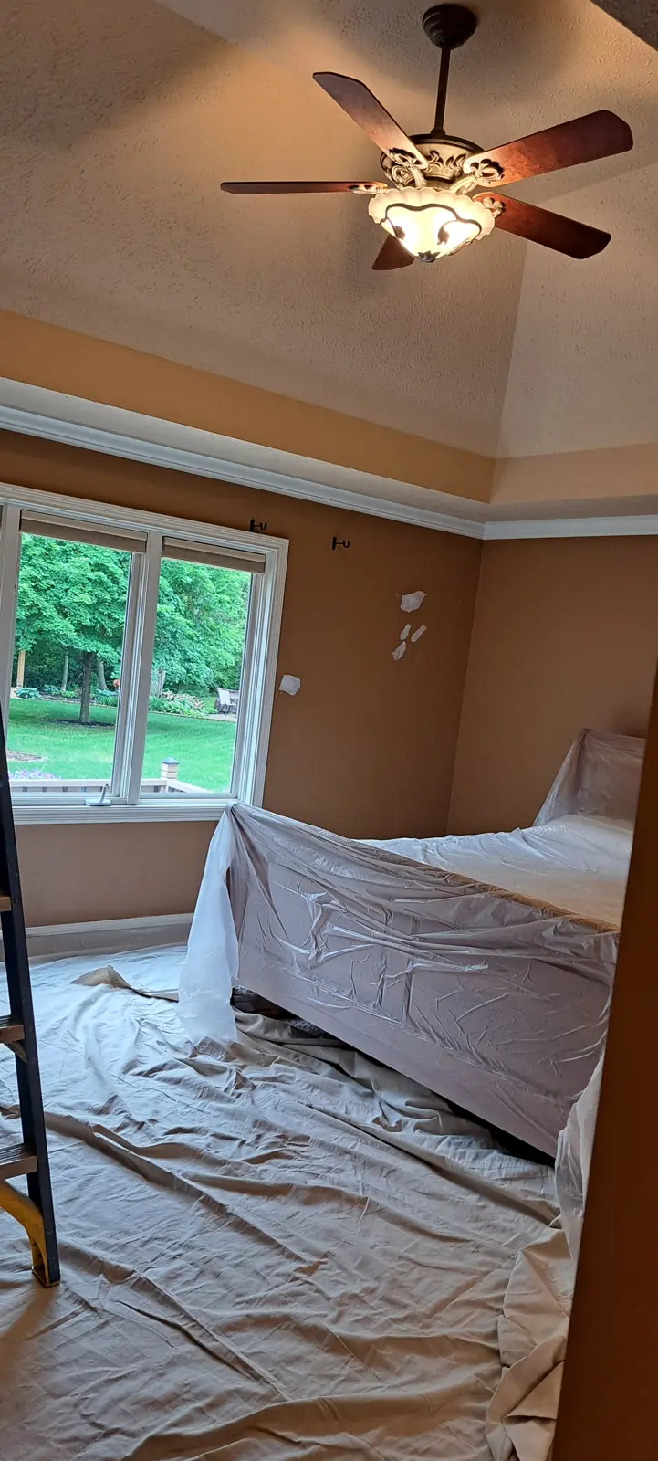 Bedroom furniture covered before interior painting