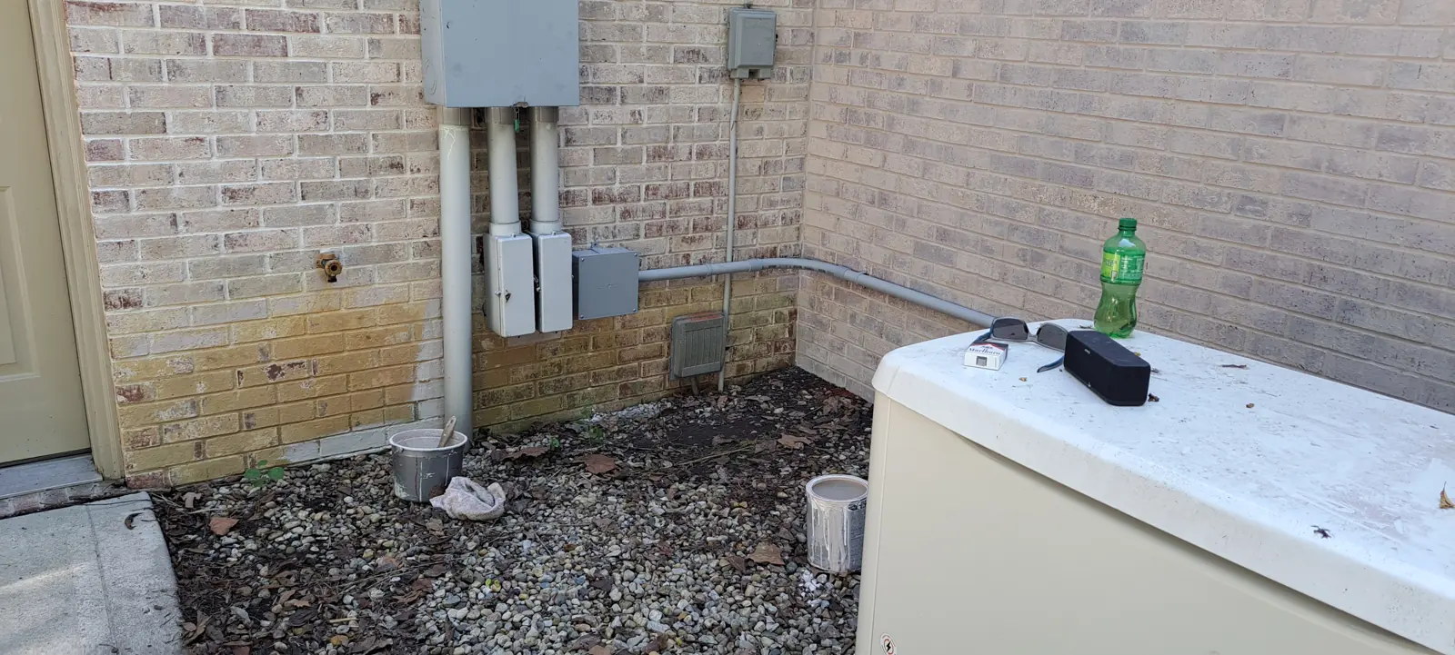 Before: Brick foundation wall washed clean of dirt and algae in Avon, IN